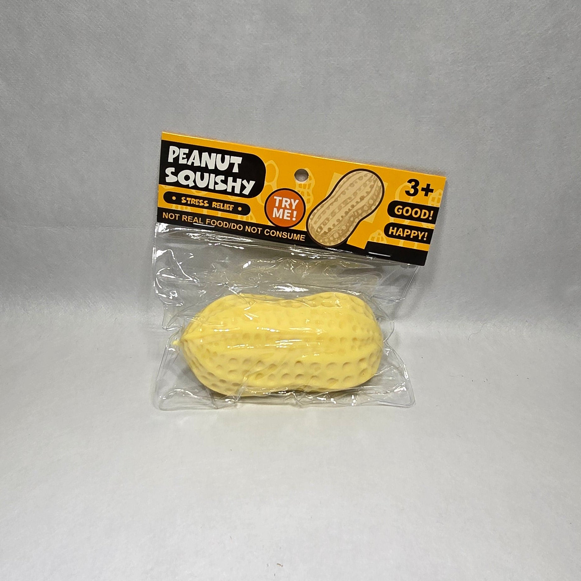 A packaged yellow textured peanut-shaped toy labeled 'PEANUT SQUISHY' on a plain light gray background.