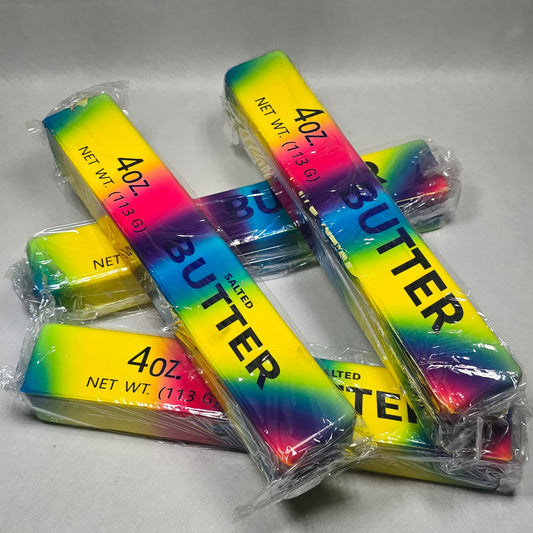 Four individually wrapped sticks of butter with a vibrant rainbow gradient label reading '4 oz' and 'BUTTER', arranged on a light gray surface.