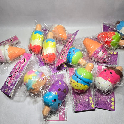 A group of small, colorful novelty squishy toys in clear plastic wrappers with purple backing cards, arranged on a light gray fabric background.